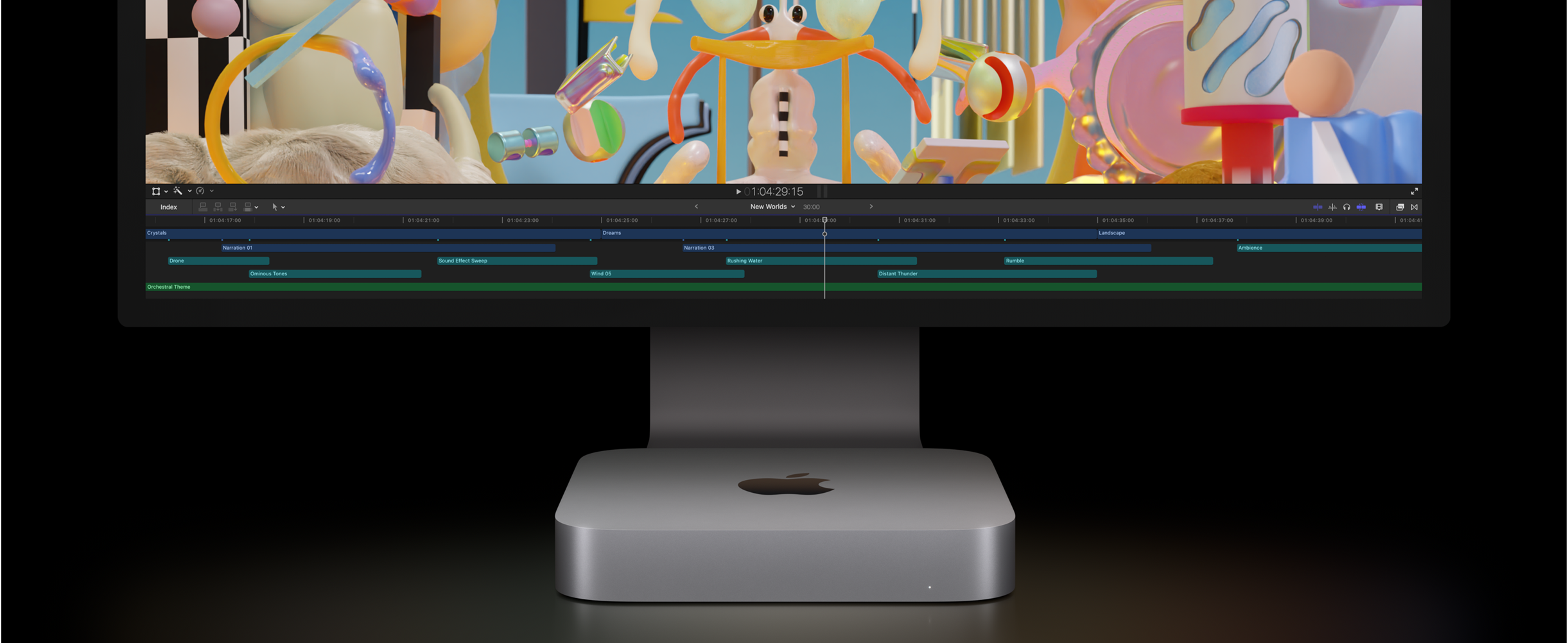 Widok z przodu Maca mini oraz monitor Studio Display przedstawiający realizację projektu montażu wideo w Final Cut Pro.