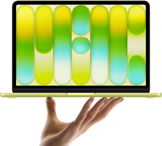 MacBook Neo w kolorze cytrusowożółtym, leżący na palcach otwartej dłoni, na ekranie widać kolorowy abstrakcyjny wzór