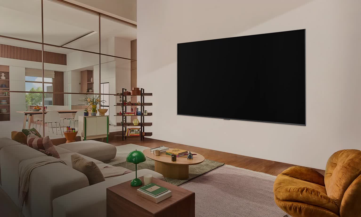 Telewizor LG zamontowany na ścianie w salonie, z gitarzystą na ekranie. Grafika koncentrycznych okręgów reprezentujących fale dźwiękowe.