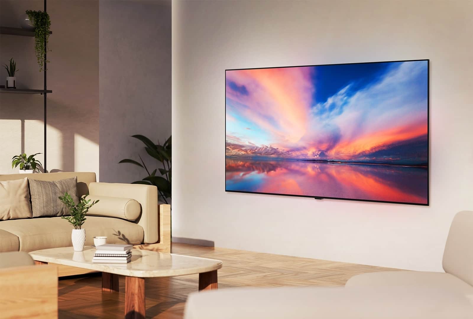 LG OLED TV, OLED B4 na ścianie neutralnego salonu, wyświetlający kolorowe zdjęcie zachodu słońca nad oceanem.