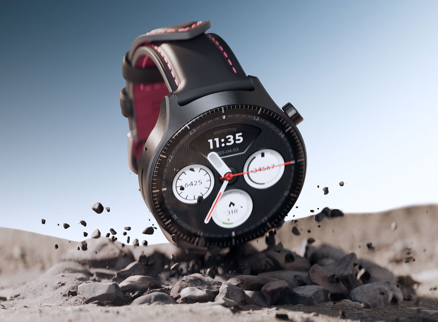 Smartwatch moto watch ultra z ciemnym paskiem leżący na kamienistym podłożu