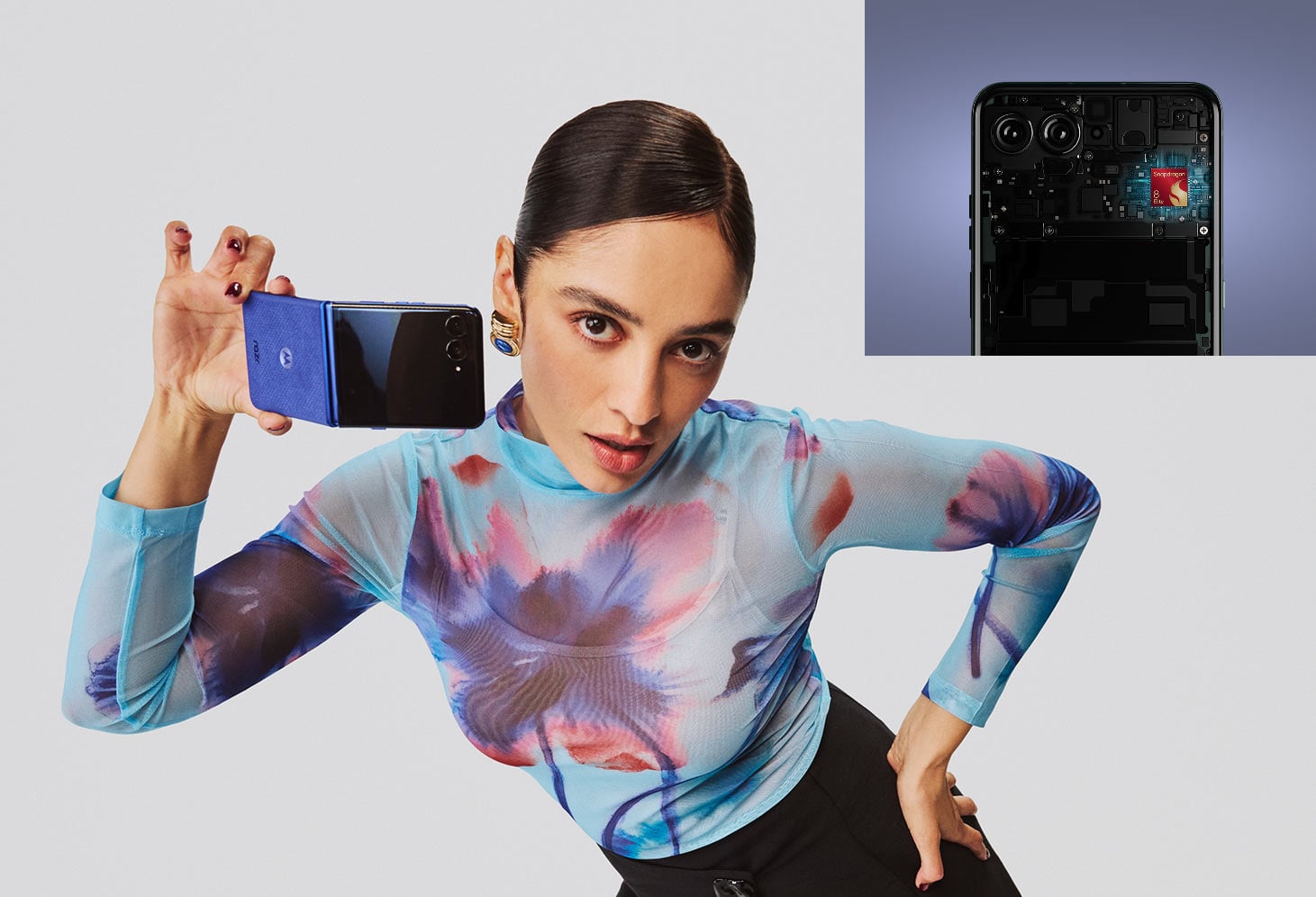 Kobieta w stylowym outficie prezentuje niebieski model razr 70 ultra.
